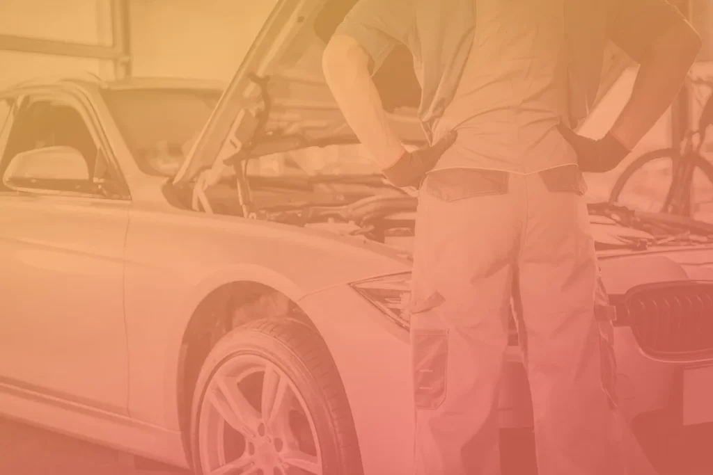 Technician looking over a vehicle